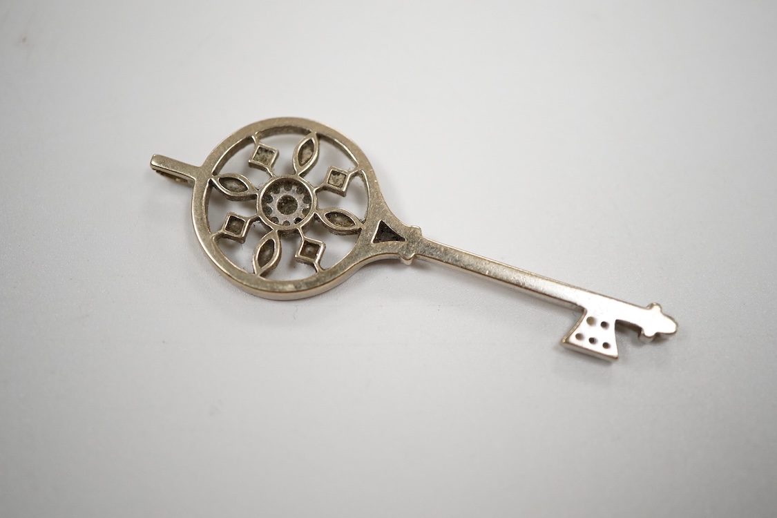 A mid 20th century white metal and diamond cluster set 'key of the door' pendant. 51mm, gross weight 4.6 grams.